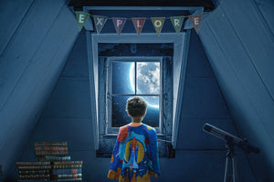 Young boy with a superhero cape looking out an attic window to the moon